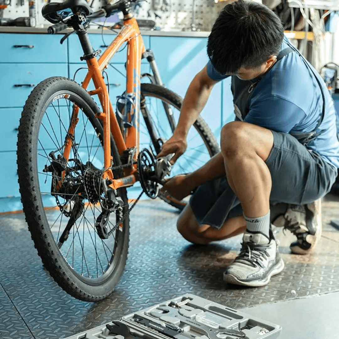 Mechanic completing a detailed bicycle maintenance service