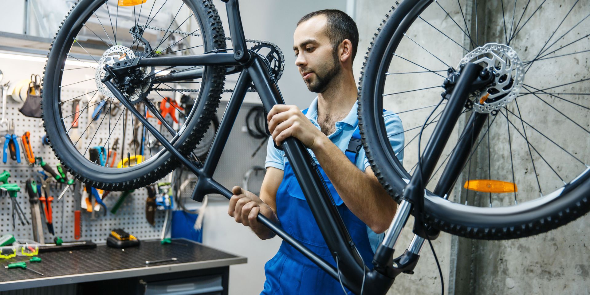 Bicycle mechanic performing detailed maintenance on a bike